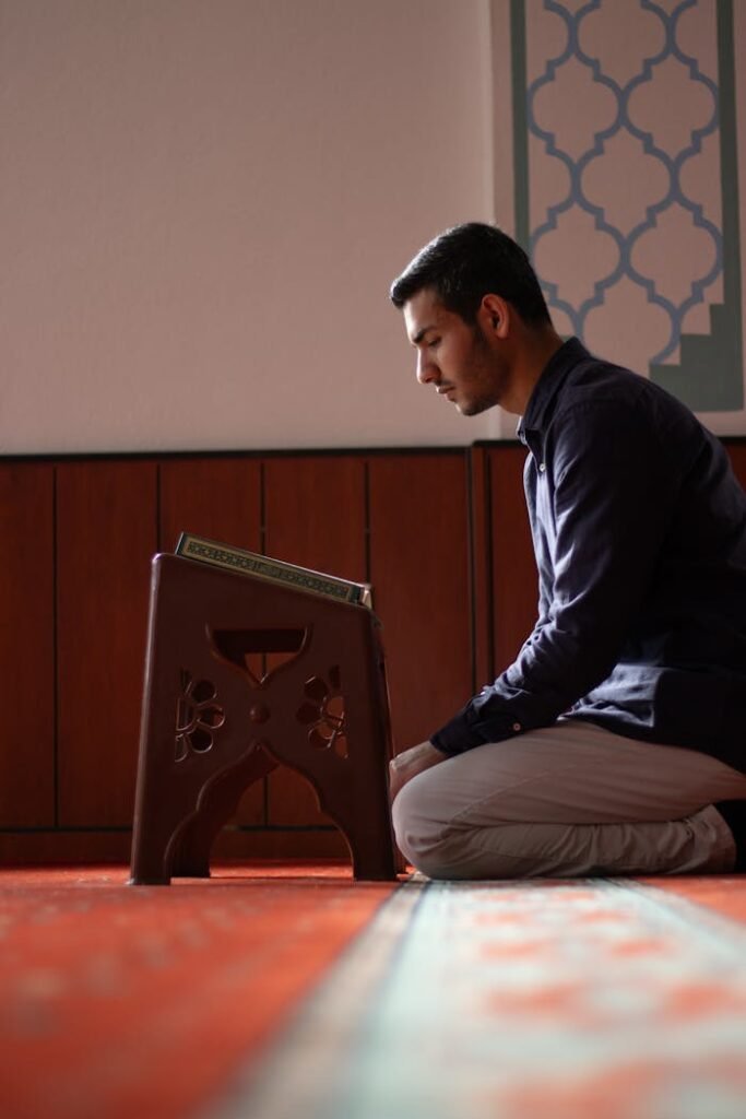 pexels-photo-30890555 A young man engaged in prayer inside a mosque, focused on spirituality and devotion.